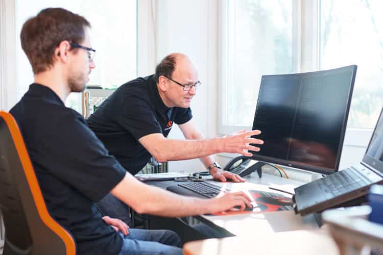 Company founder Helmut Singer shares his knowledge of stepper motor control with a young engineer
