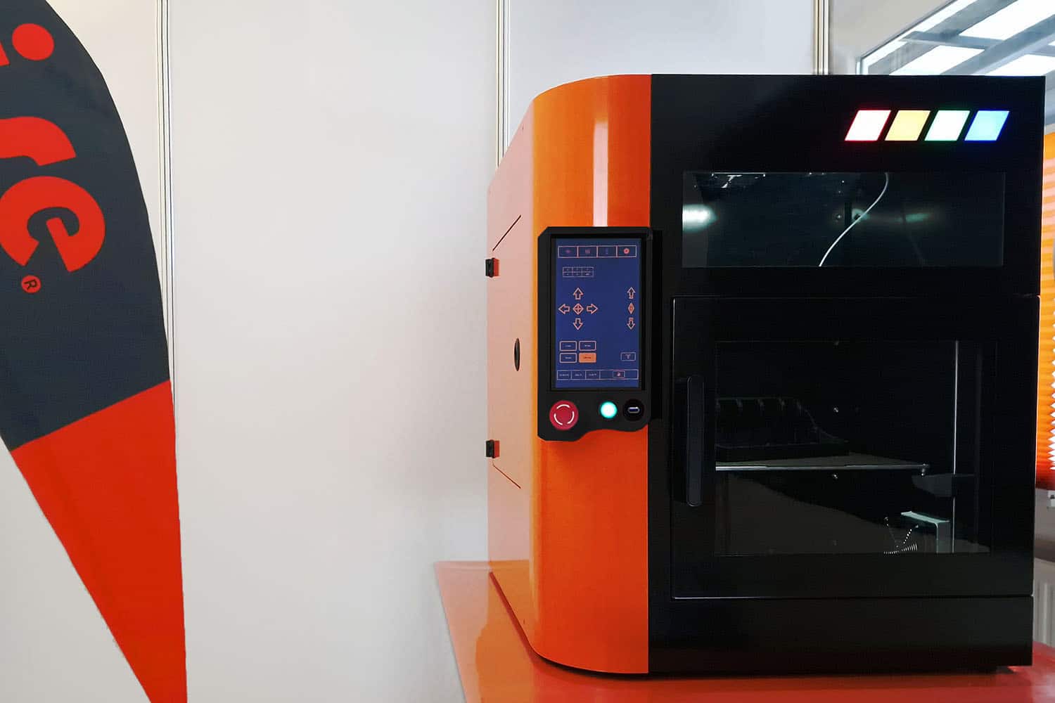 isePRINT industrial 3D printer with orange enclosure and operator panel